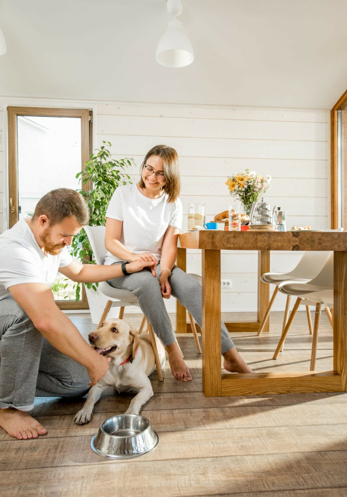 Young couple with dog at home | Panter's Hardwood Floors & More